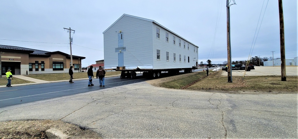 Continuing making history: Contractors move last two World War II-era barracks to new locations