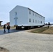 Continuing making history: Contractors move last two World War II-era barracks to new locations