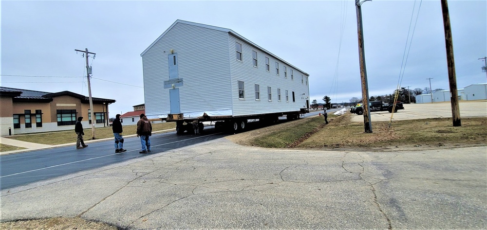 Continuing making history: Contractors move last two World War II-era barracks to new locations