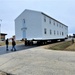 Continuing making history: Contractors move last two World War II-era barracks to new locations