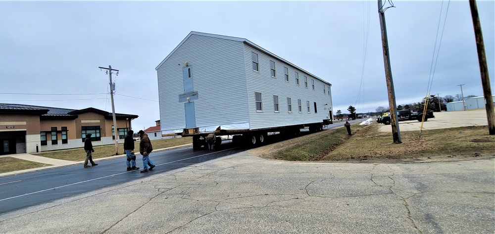 Continuing making history: Contractors move last two World War II-era barracks to new locations