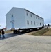 Continuing making history: Contractors move last two World War II-era barracks to new locations