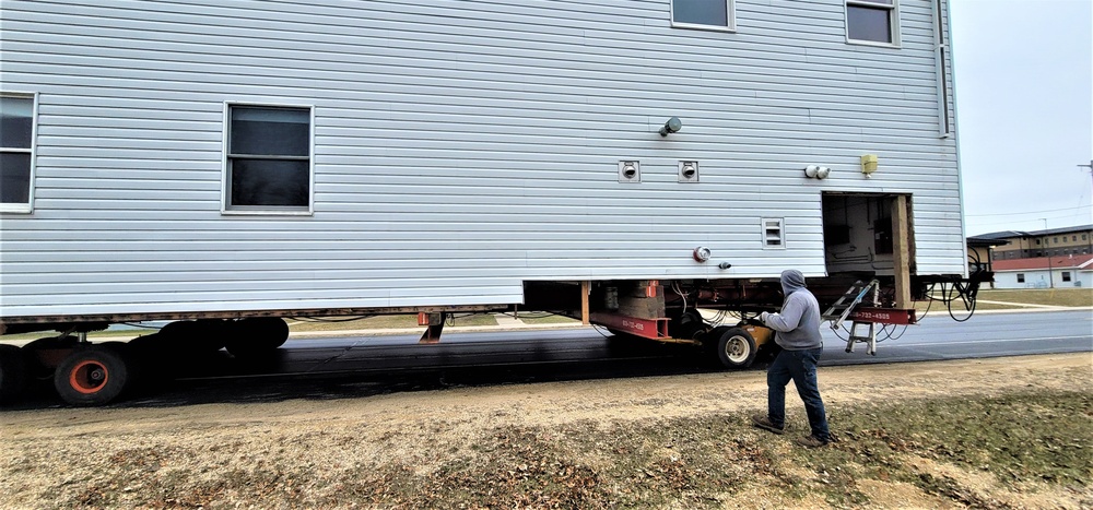 Continuing making history: Contractors move last two World War II-era barracks to new locations