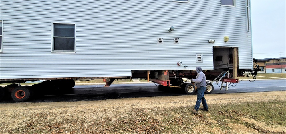 Continuing making history: Contractors move last two World War II-era barracks to new locations