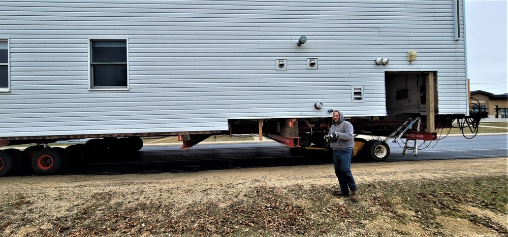 Continuing making history: Contractors move last two World War II-era barracks to new locations