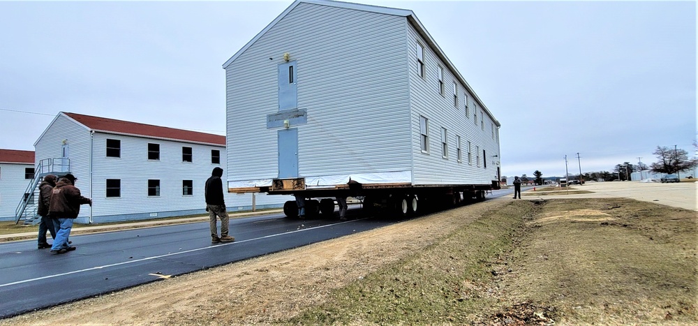 Continuing making history: Contractors move last two World War II-era barracks to new locations