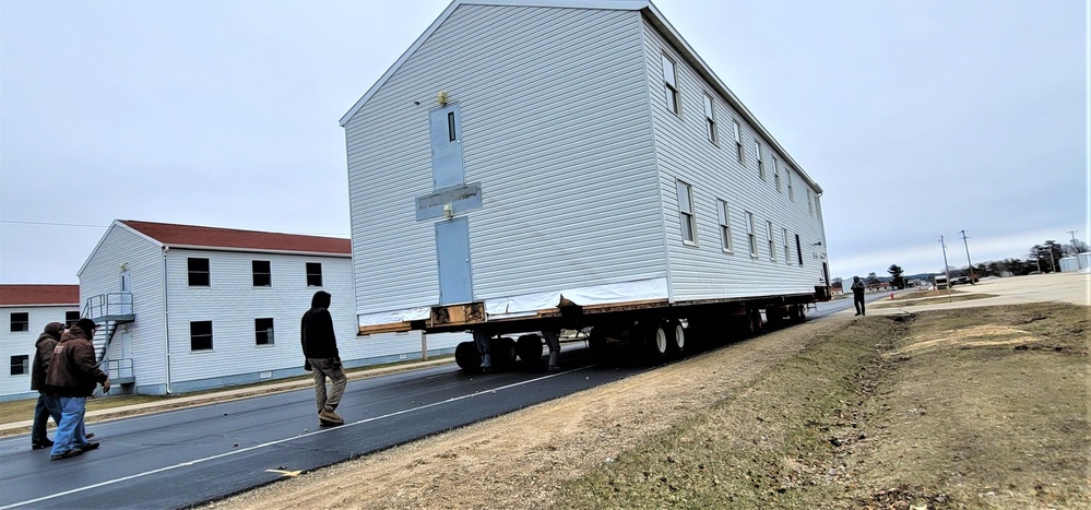 Continuing making history: Contractors move last two World War II-era barracks to new locations