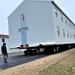 Continuing making history: Contractors move last two World War II-era barracks to new locations