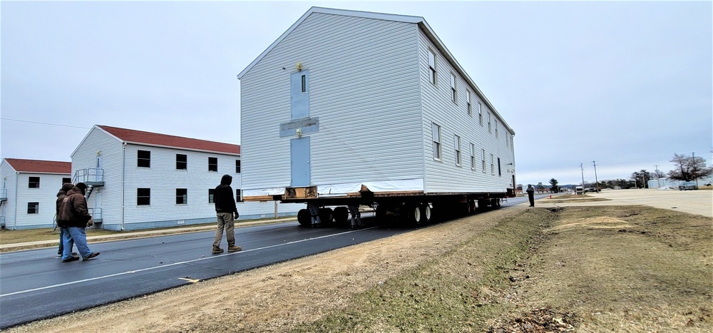 Continuing making history: Contractors move last two World War II-era barracks to new locations