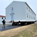 Continuing making history: Contractors move last two World War II-era barracks to new locations