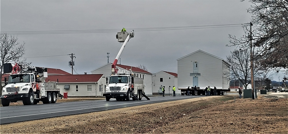 Continuing making history: Contractors move last two World War II-era barracks to new locations