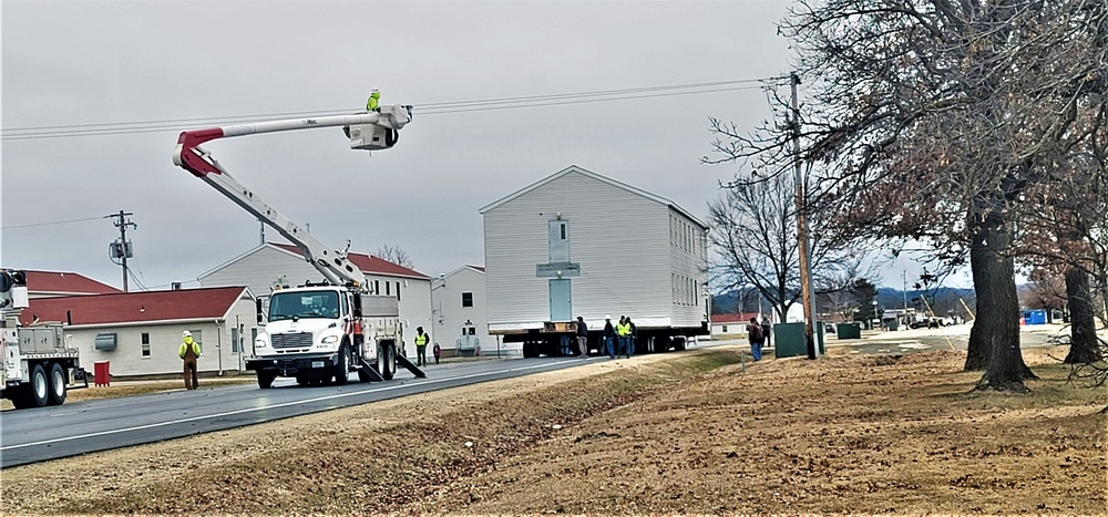 Continuing making history: Contractors move last two World War II-era barracks to new locations