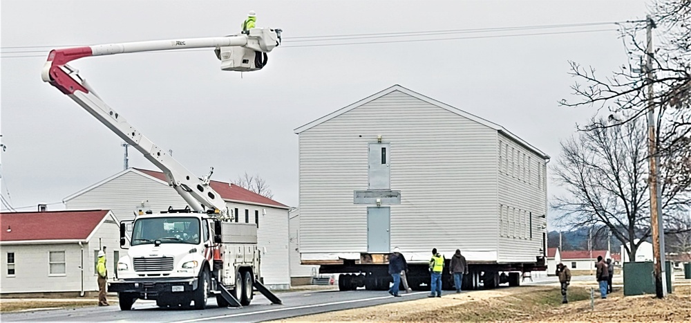 Continuing making history: Contractors move last two World War II-era barracks to new locations