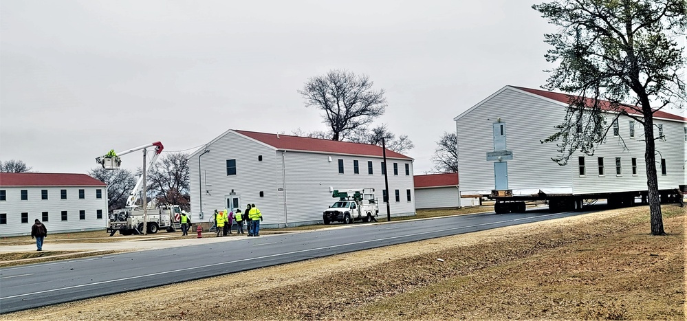 Continuing making history: Contractors move last two World War II-era barracks to new locations