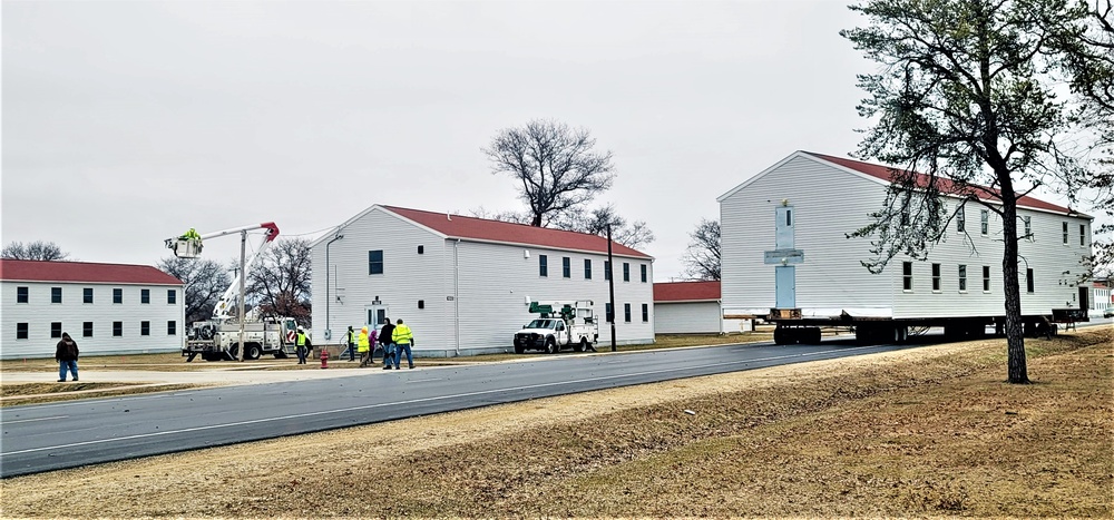 Continuing making history: Contractors move last two World War II-era barracks to new locations