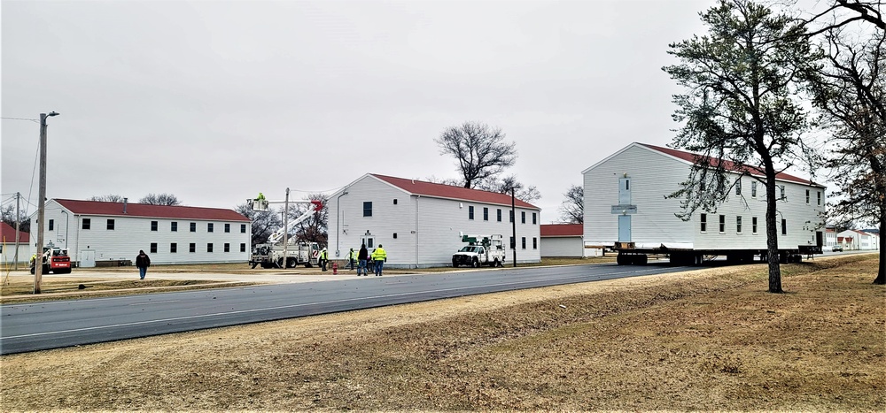 Continuing making history: Contractors move last two World War II-era barracks to new locations