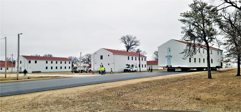 Continuing making history: Contractors move last two World War II-era barracks to new locations