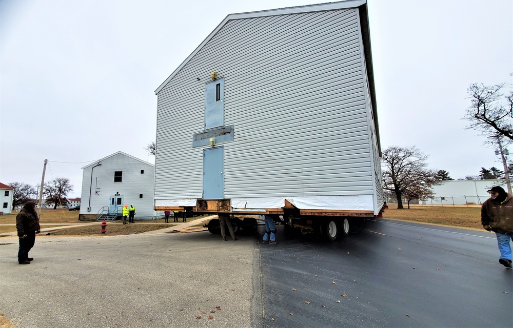 Continuing making history: Contractors move last two World War II-era barracks to new locations