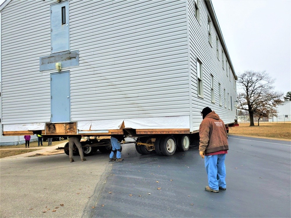 Continuing making history: Contractors move last two World War II-era barracks to new locations