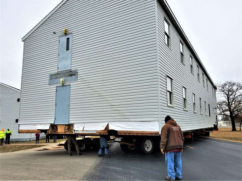 Continuing making history: Contractors move last two World War II-era barracks to new locations