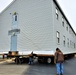 Continuing making history: Contractors move last two World War II-era barracks to new locations