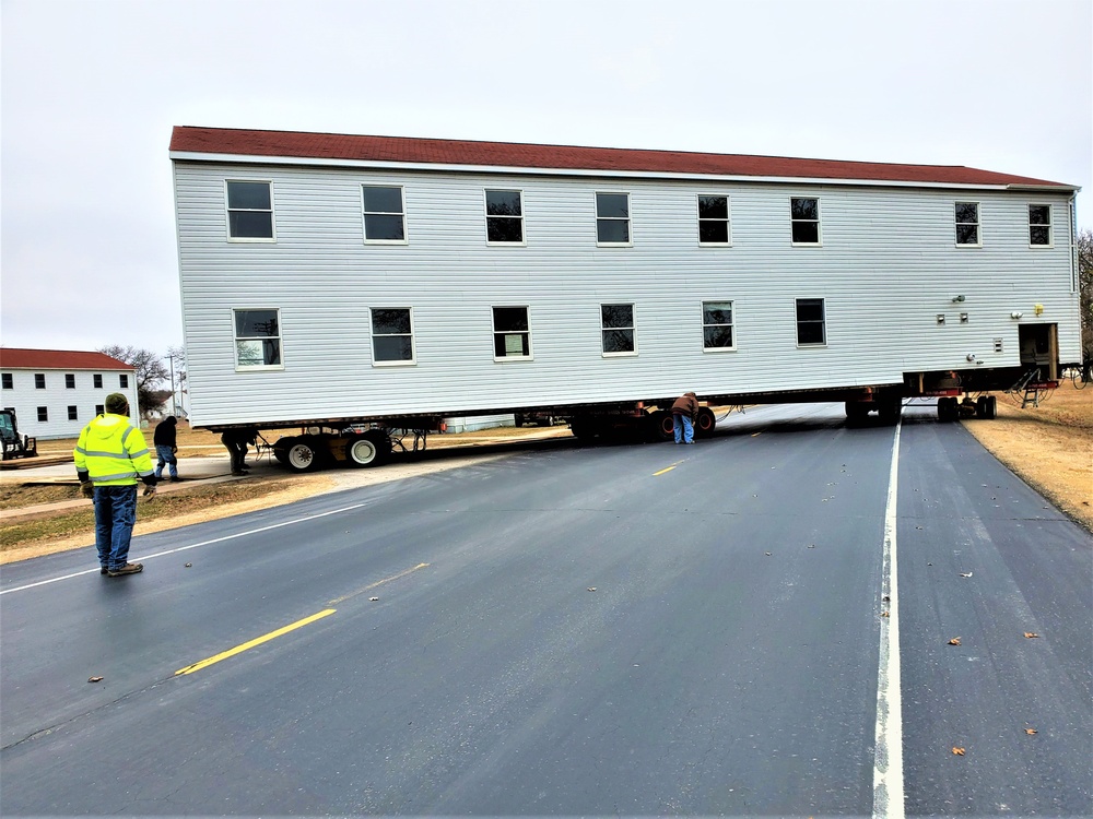 Continuing making history: Contractors move last two World War II-era barracks to new locations