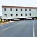 Continuing making history: Contractors move last two World War II-era barracks to new locations