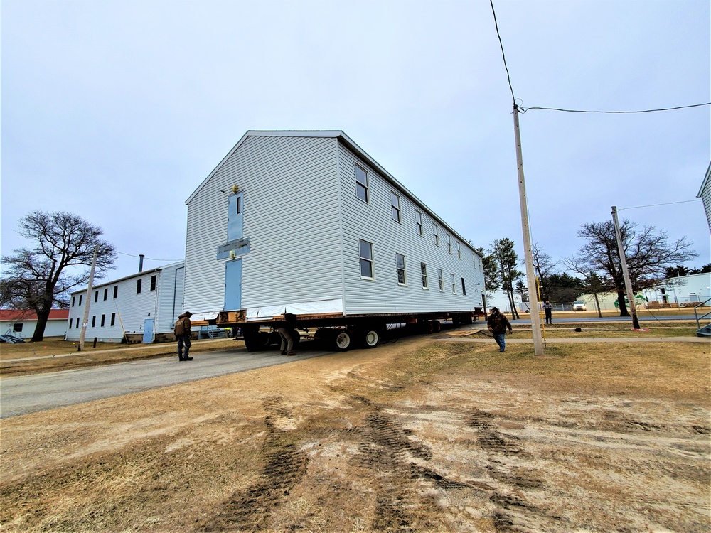 Continuing making history: Contractors move last two World War II-era barracks to new locations