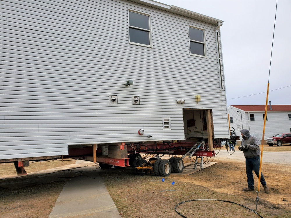 Continuing making history: Contractors move last two World War II-era barracks to new locations