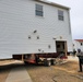 Continuing making history: Contractors move last two World War II-era barracks to new locations