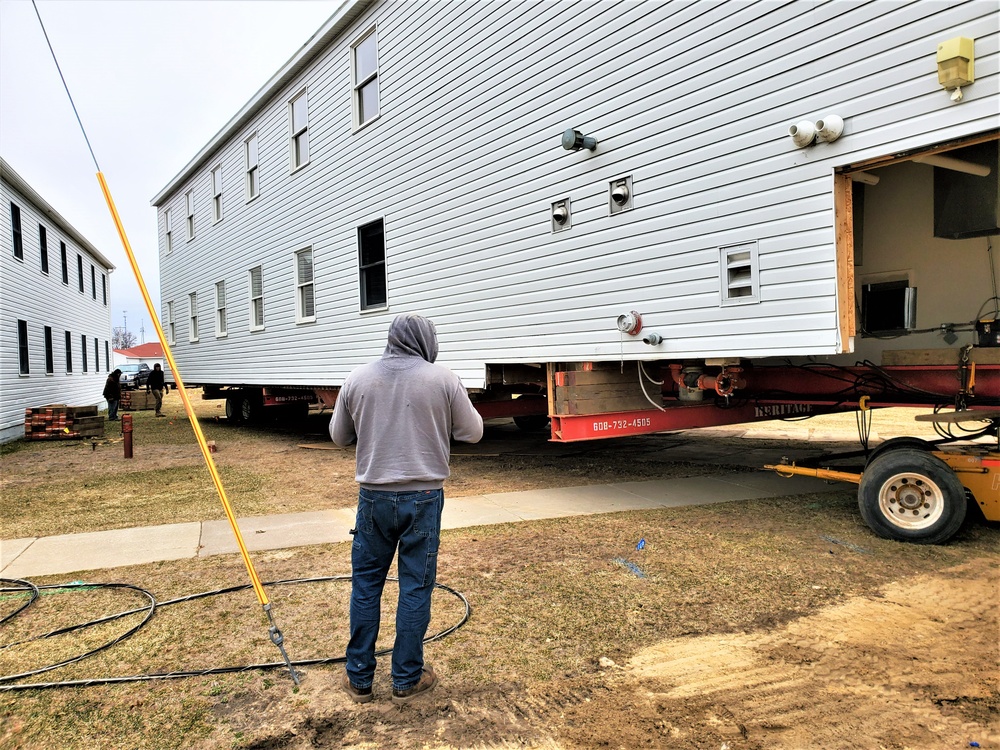 Continuing making history: Contractors move last two World War II-era barracks to new locations