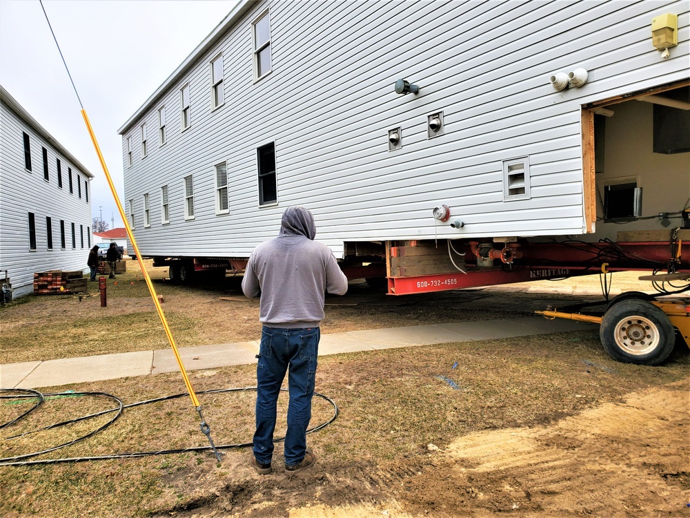 Continuing making history: Contractors move last two World War II-era barracks to new locations