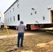 Continuing making history: Contractors move last two World War II-era barracks to new locations