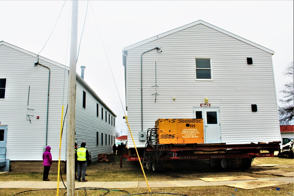 Continuing making history: Contractors move last two World War II-era barracks to new locations