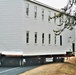 Continuing making history: Contractors move last two World War II-era barracks to new locations