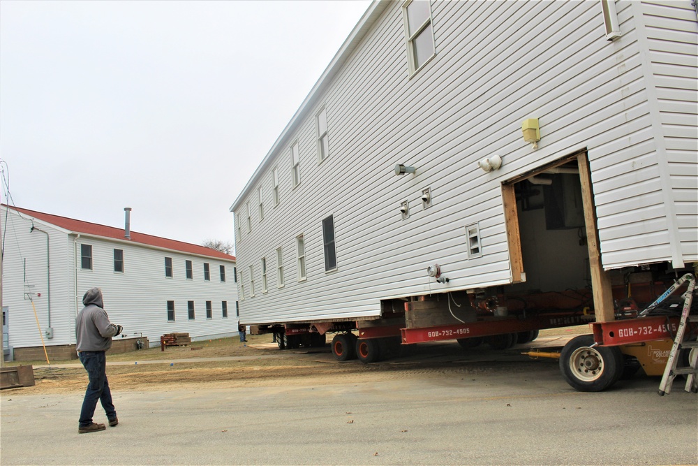 Continuing making history: Contractors move last two World War II-era barracks to new locations