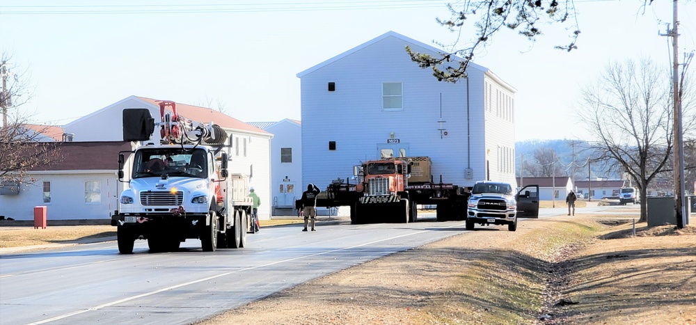 Continuing making history: Contractors move last two World War II-era barracks to new locations