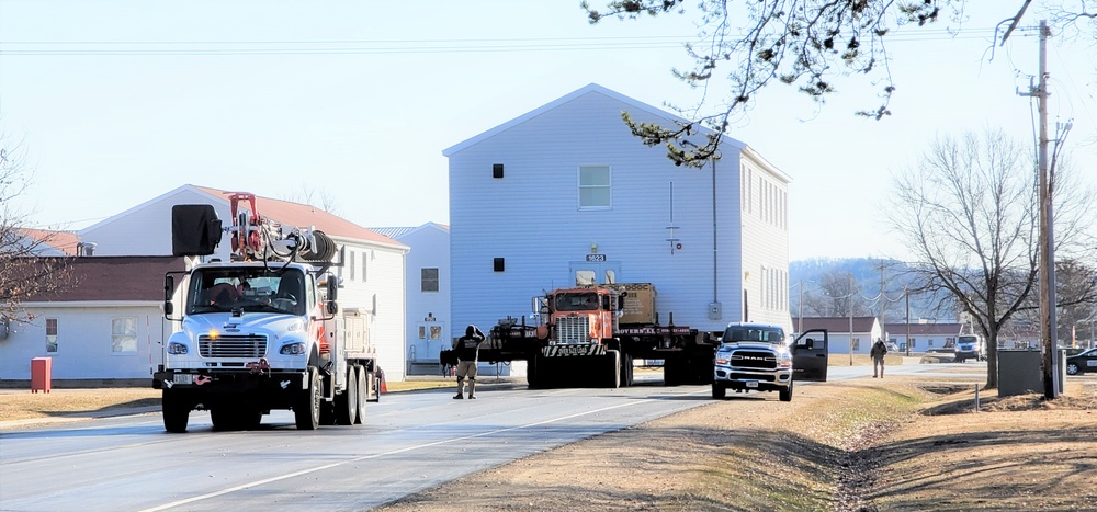 Continuing making history: Contractors move last two World War II-era barracks to new locations