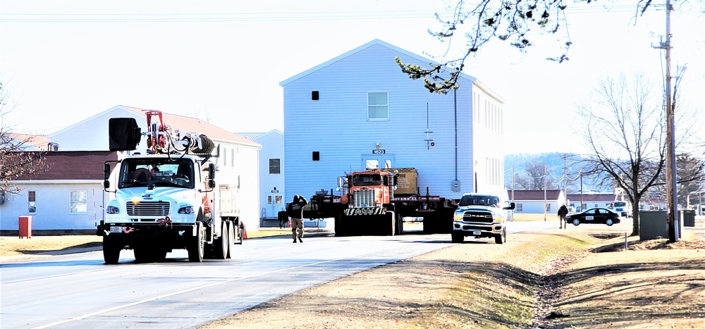 Continuing making history: Contractors move last two World War II-era barracks to new locations