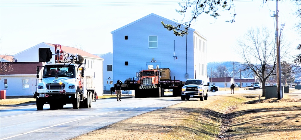 Continuing making history: Contractors move last two World War II-era barracks to new locations