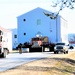 Continuing making history: Contractors move last two World War II-era barracks to new locations