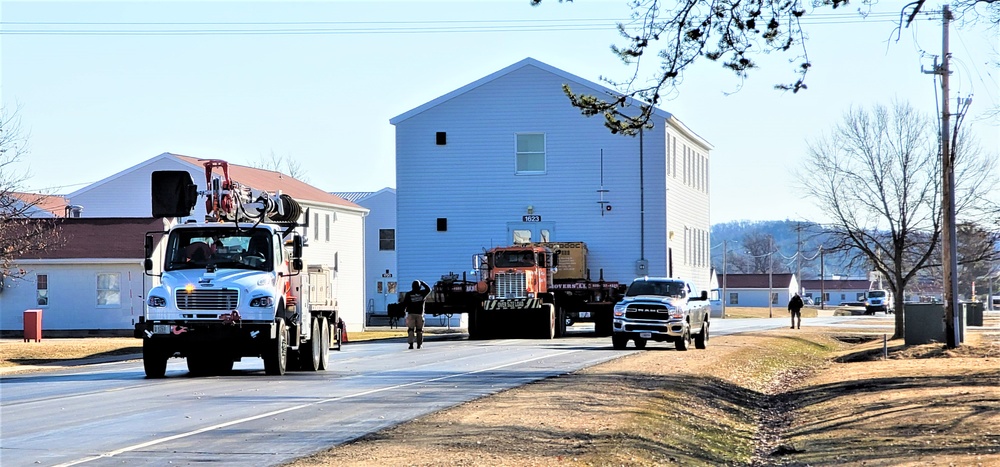 Continuing making history: Contractors move last two World War II-era barracks to new locations