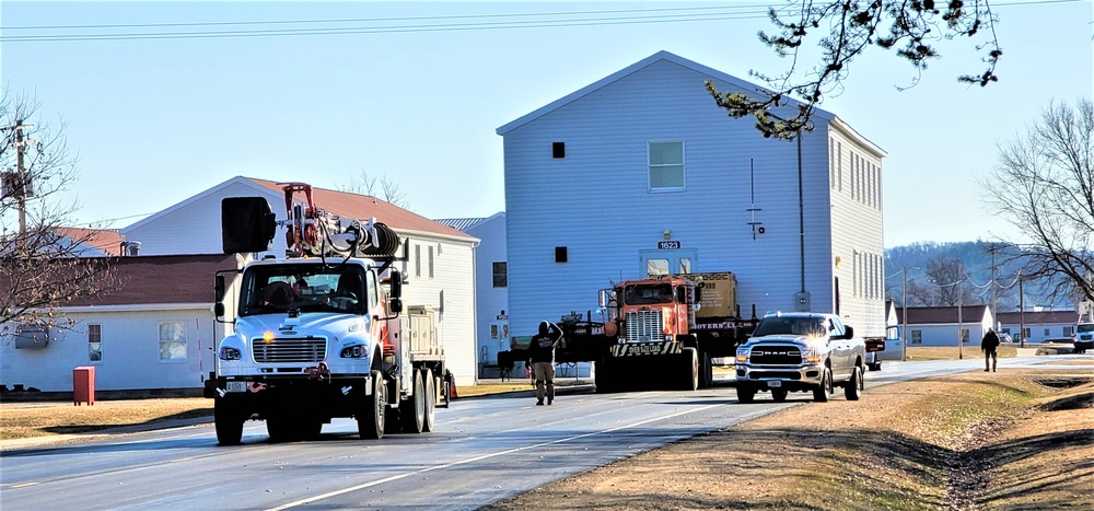 Continuing making history: Contractors move last two World War II-era barracks to new locations