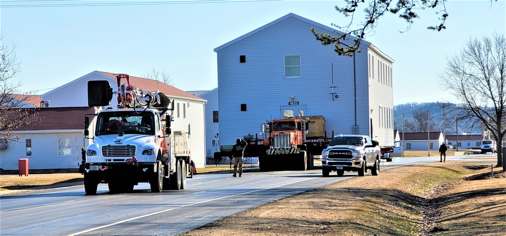 Continuing making history: Contractors move last two World War II-era barracks to new locations