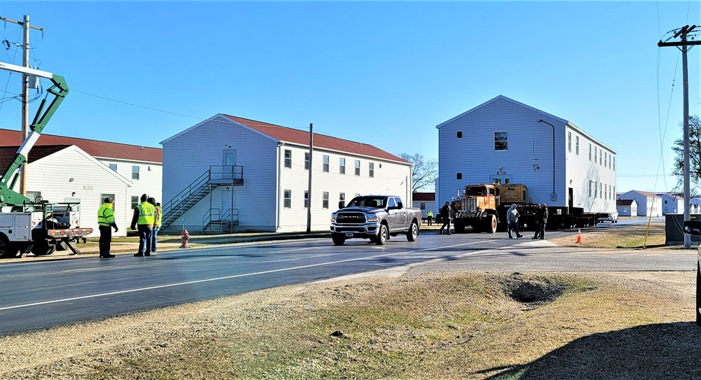 Continuing making history: Contractors move last two World War II-era barracks to new locations