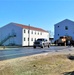 Continuing making history: Contractors move last two World War II-era barracks to new locations