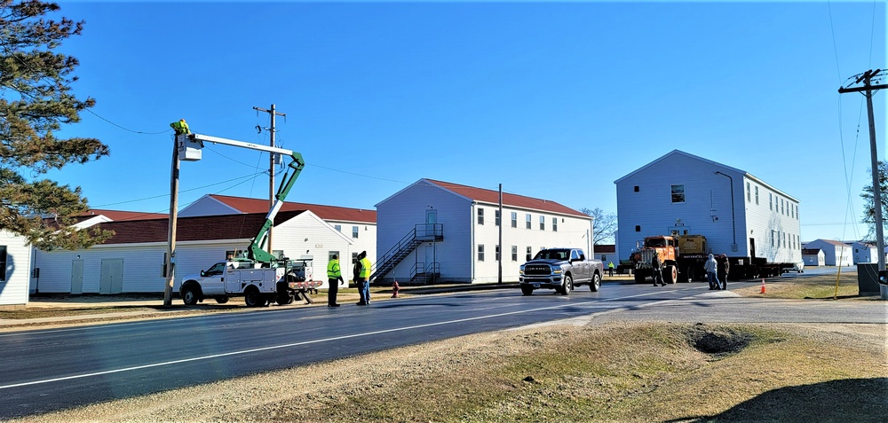 Continuing making history: Contractors move last two World War II-era barracks to new locations