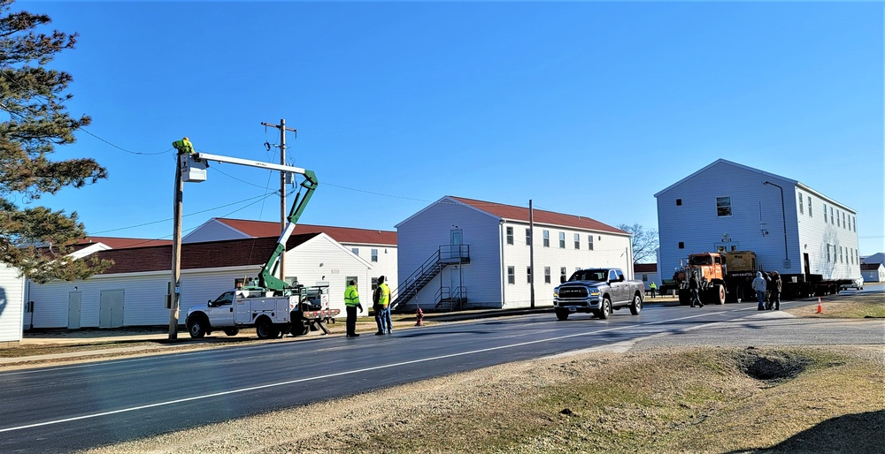 Continuing making history: Contractors move last two World War II-era barracks to new locations