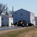 Continuing making history: Contractors move last two World War II-era barracks to new locations