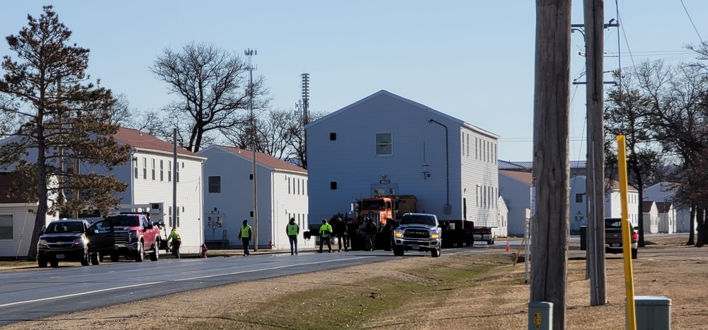 Continuing making history: Contractors move last two World War II-era barracks to new locations